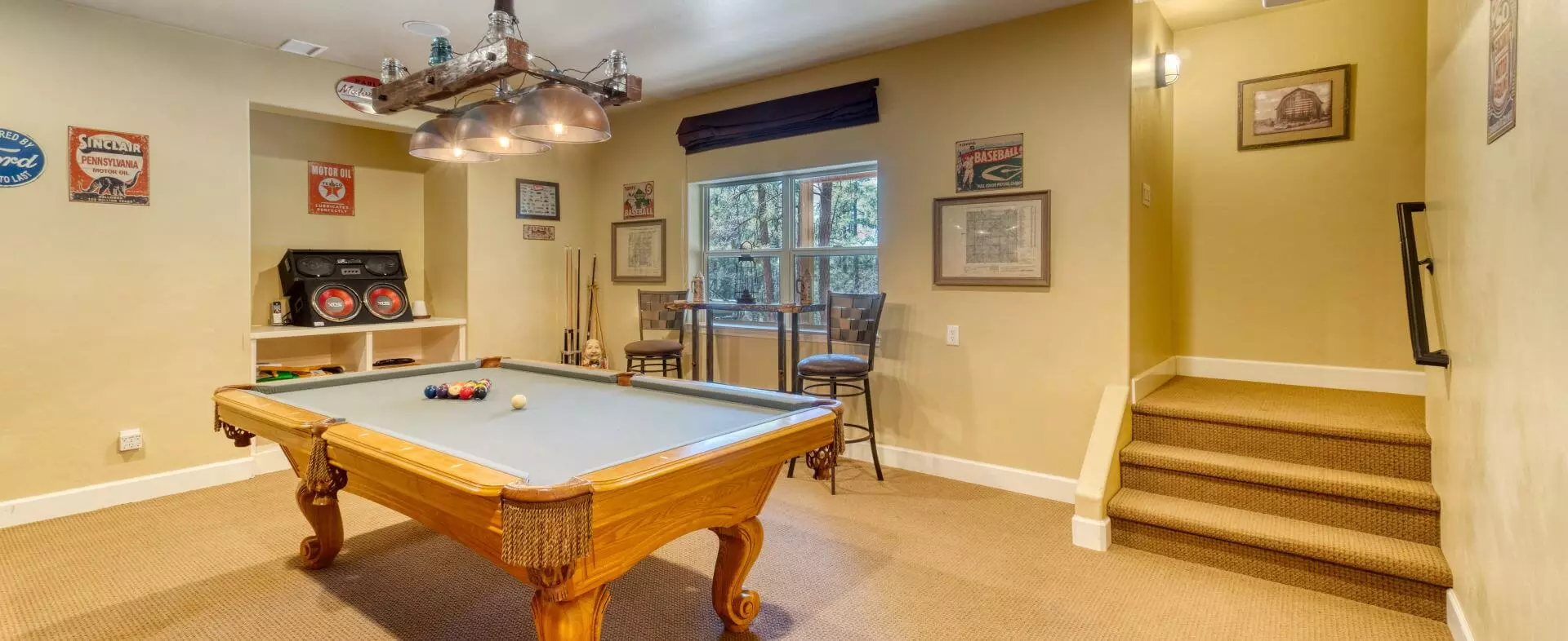 A finished basement with a billiards table