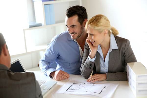 Happy Couple talking with builder