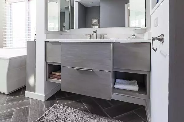 Floating vanity shows floor tiles below