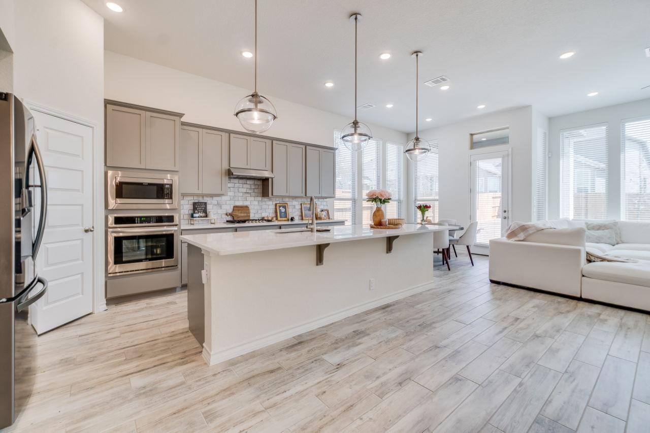 Beautiful kitchen with ceramic tile flooring that looks like wood